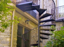 custom wrought iron spiral staircase connected to porch railing from finelli architectural iron and stairs
